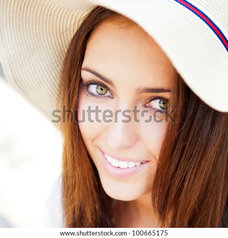 Beautiful young elegant woman wearing hat outdoor at park she is relaxed and daydreaming