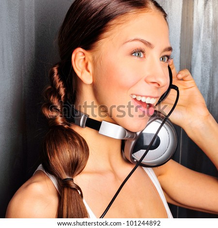 Club style woman with headphones listening to music