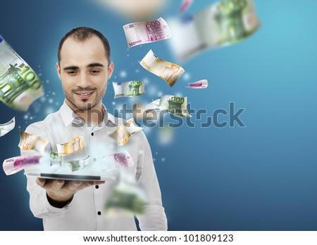 Portrait of young man holding the tablet pc and Money Coming out of Touch screen. Concept of business growth and e-trade