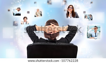Portrait of businesswoman from behind communicating with her team across the world. International communications concept