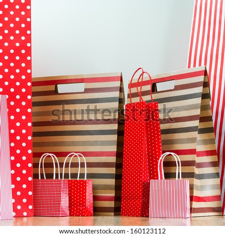 Assorted shopping and gift red paper bags - shopping and holiday concept with copyspace