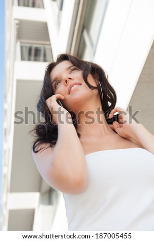 Successful businesswoman or entrepreneur talking on mobile phone while walking outdoor. City business woman working.