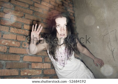 Young beautiful scared addict girl inside abandoned building