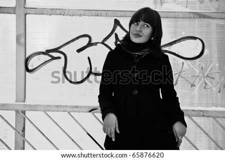 Outdoor portrait of young beautiful european style woman - walking through tunnel black & white french style photo