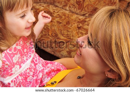 happy family, young beautiful mother and her little daughter indoor at home