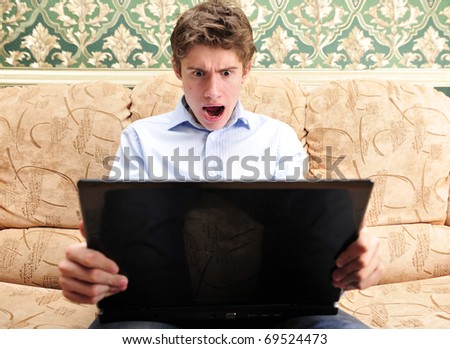Business man working on computer at home and surprised by fast internet connection
