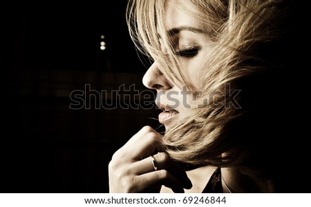 Portrait of adult attractive woman indoor in dark room