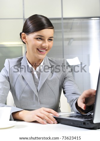 Beautiful business woman dreaming while working on computer at her office