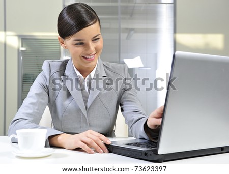 Beautiful business woman dreaming while working on computer at her office
