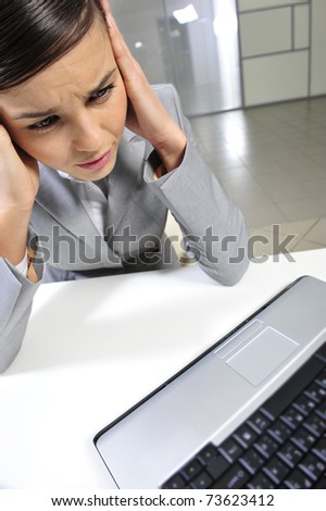 Beautiful business woman thinking about something while working on computer at her office