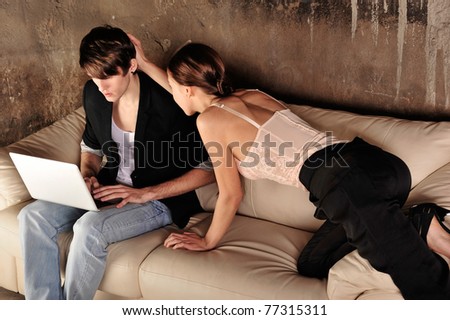 Fashion style photo of an attractive young couple at their grunge apartment at evening