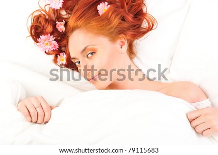 Fashion photo of beautiful nude woman with magnificent hair and flowers