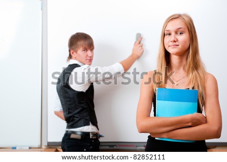 Portrait of college students making presentation of their project in classroom