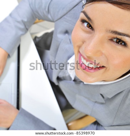 Beautiful business woman thinking about somethinking while working no computer at her office. Photo from above