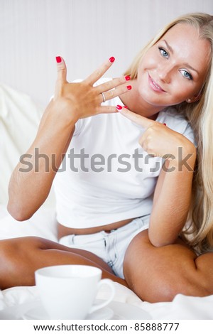Happy young woman showing her proposal ring from her boyfriend. She is very happy