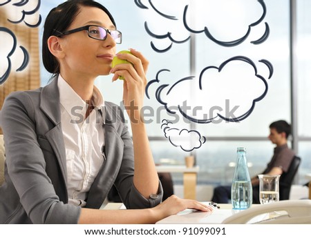 Portrait of a beautiful young businesswoman thinking. Office background. Blank cloud balloons with her thoughts flying around her