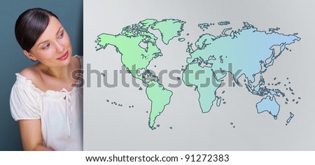 Attractive brunette young woman standing near board with world map. International service or traveling concept