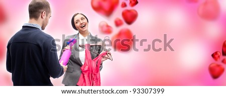 Portrait of adult business man and woman preparing to corporate party. Man gifting cute dress and wine to his colleague. Office romance concept. Romantic background with graphic hearts