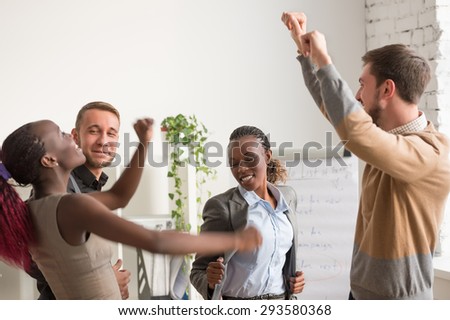 Business team celebrating a good job in the office