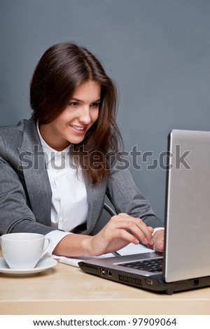 Beautiful business woman thinking about something while working no computer at her office