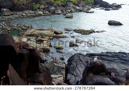 PALOLEM, GOA, INDIA - FEBRUARY 2015: people meditate on a beach during general meditation. Meditation - one of important constituents of rest on Goa