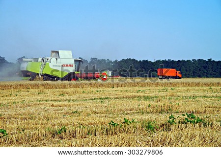 POLTAVA, UKRAINE - 04 AUGUST 2015: Combines harvested wheat. In Poltava area summer harvest in full swing.