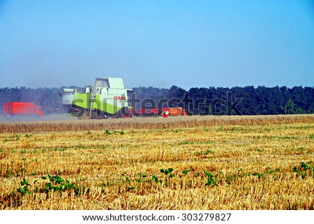 POLTAVA, UKRAINE - 04 AUGUST 2015: Combines harvested wheat. In Poltava area summer harvest in full swing.