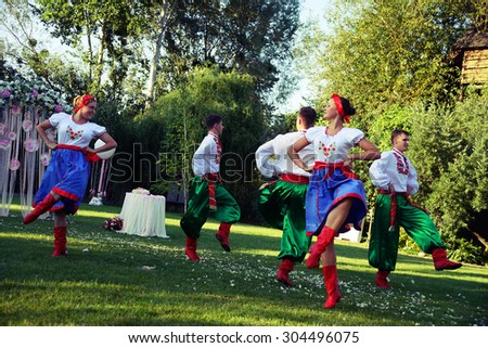 POLTAVA, UKRAINE - AUGUST 2015: a local cossack dancing group dances in a park. Ukrainians love to dance and sing.