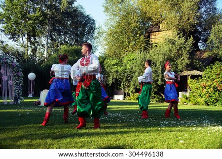 POLTAVA, UKRAINE - AUGUST 2015: a local cossack dancing group dances in a park. Ukrainians love to dance and sing.