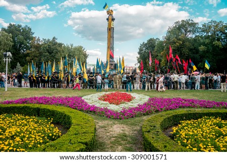 POLTAVA, UKRAINE - 23 AUGUST 2015: local residents and members of the volunteer battalions Celebrate Flag Day of Ukraine. Established flag on the tower.