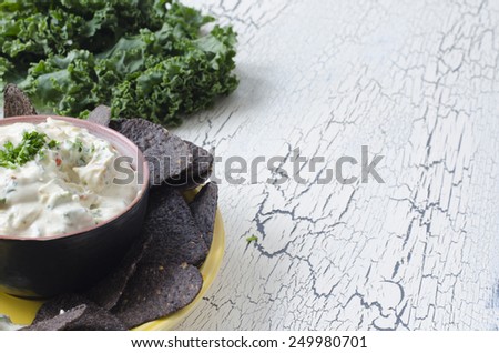blue corn tortilla chips with ranch vegetable dip kale and copy space