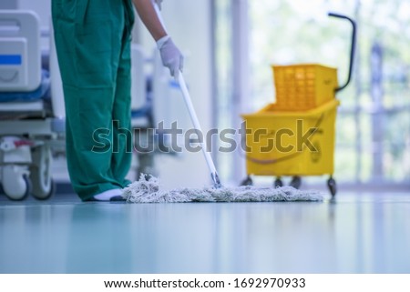 Blurred hospital images, Clean and sanitize, Cleaner, Hospital cleaning,Cleaning the hospital floor. Floor care and cleaning services with washing mop in sterile factory or clean hospital.