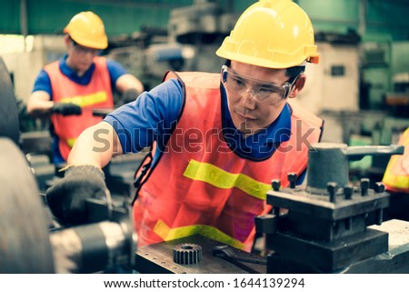 The industrial factory inspector wearing safety helmet and goggle watching on measurement tools on factory machine equipments to keep tracking value of iron stress, Concept annual safety auditing. Stock photo © 