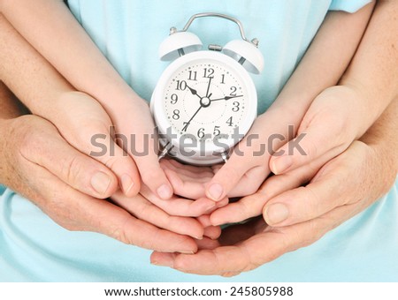 Family time - Father, Mother, and Child holding an alarm clock
