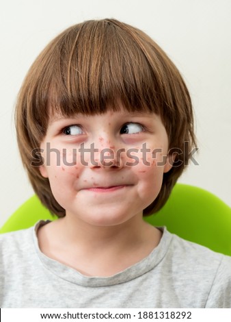 Similar – Image, Stock Photo Boy sits in front of green wall and grins