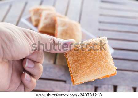 Crackers butter sugar three piece on saucer and one piece on hand, stock photo
