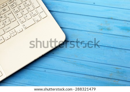 The part of laptop computer on blue table
