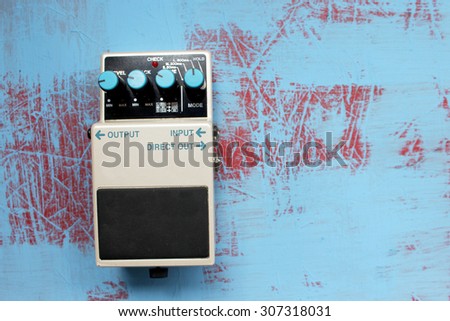 Guitar pedal on grunge background