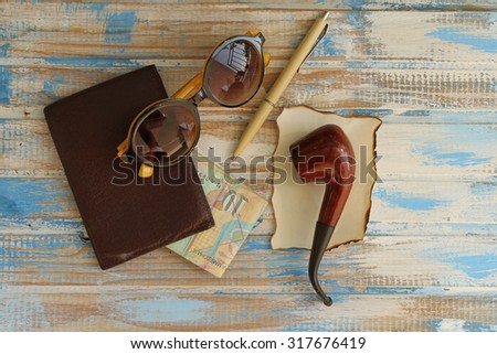Retro fashion concept - smoking pipe, pen, sunglasses, wallet and money