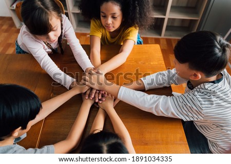 Group of school friends with hands stacked one on top of another, friendship, support, togetherness. Multiethnic school children with hands touching on top of each other Stock foto © 