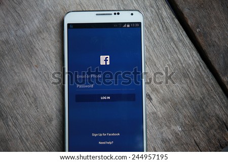 BANGKOK-January 18 2015: Facebook\'s Log In Home Page on Mobile Phone. Facebook is is an online social networking service headquartered in Menlo Park, California.