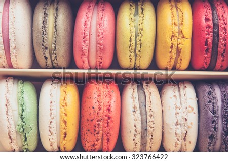 Stack of colorful macaroons stacked up in the box for background - in vintage tone