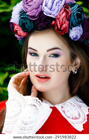 Portrait of Beautiful woman with fashion makeup wearing beautiful flower wreath