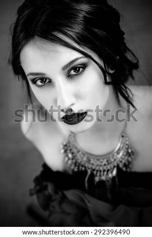 Beautiful woman with cute face bright make up red lips and piercing on nose black and white photo
