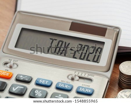 Tax word and 2020 number on calculator. Business and tax concept. Pay tax in 2020 years.