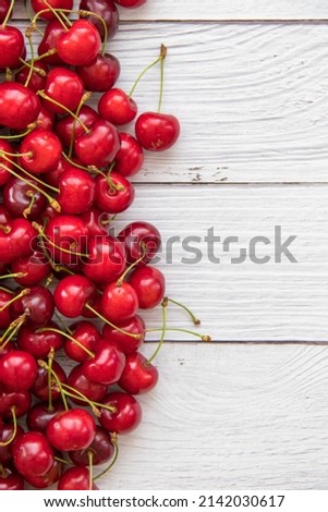 Similar – Image, Stock Photo Ripe cherries in wooden basket on grass. Container full of fruits