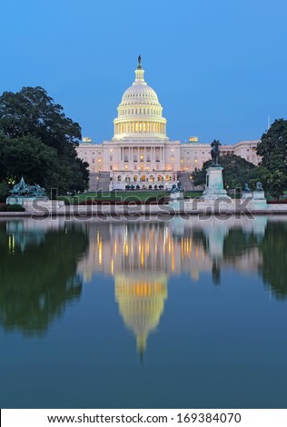 The west side of the United States Capitol building and Ulysses S Grant memorial in Washington, DC reflected in the reflecting pool just after sunset vertical