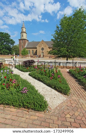 WILLIAMSBURG, VIRGINIA - APRIL 21 2012: Gardens of Colonial Williamsburg in front of Bruton Parish Church in spring. The restored town is a major attraction for tourists and meetings of world leaders.