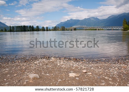Bridge over the Fraser River in British Columbia, Canada, with blue sky and white clouds