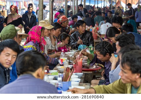 SAPA, VIETNAM - MARCH 16: Unidentified crowd of villagers interact during busy lunch hour at large sheltered tents near open market on March 16, 2015 at Sapa, Vietnam